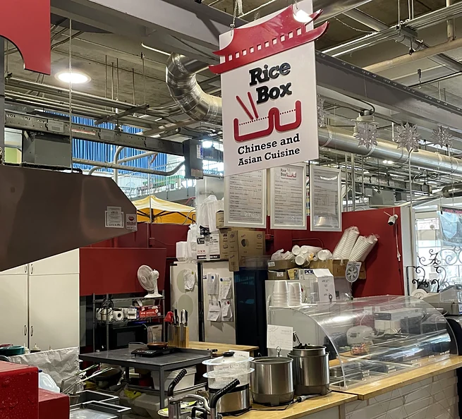 The Rice Box counter and sign inside Covent Garden Market